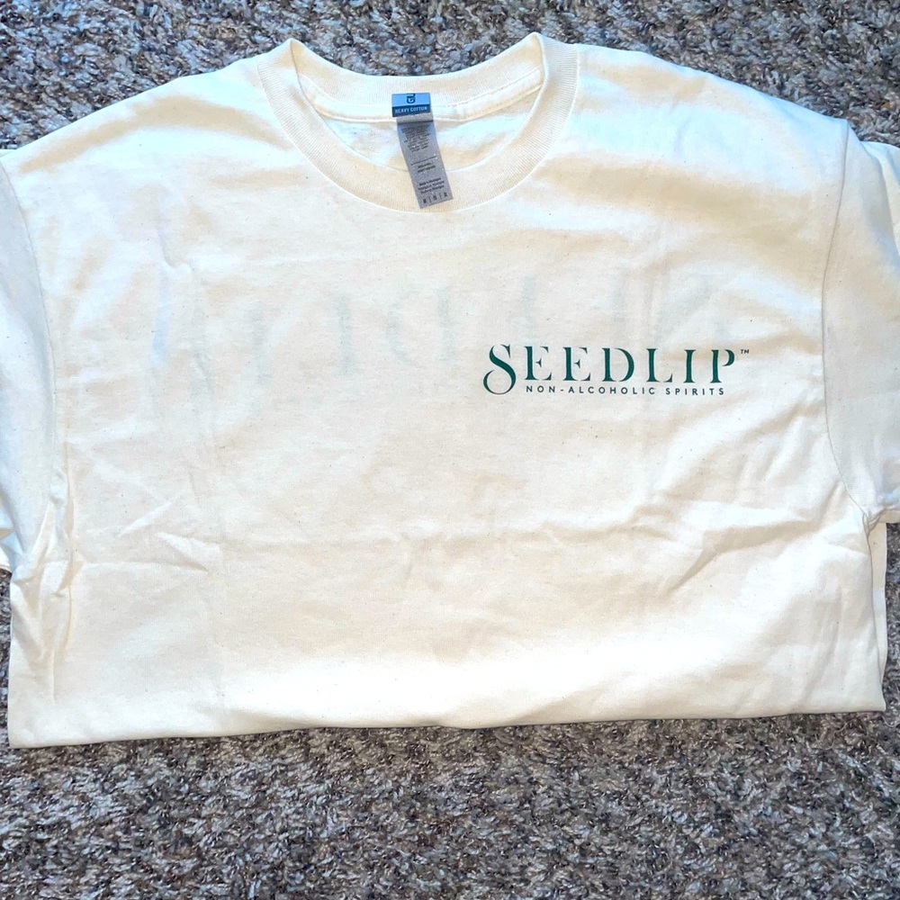 A seedlip Tshirt with beautiful keychain & Cocktail Swizzle sticks.